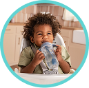 Baby drinking from a NUK learner straw cup
