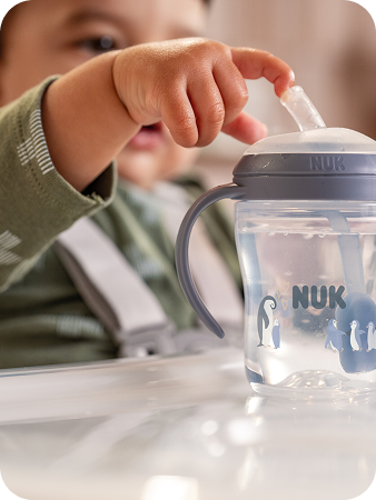 Parent and toddler with NUK cup