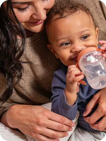 Baby drinking from a NUK learner cup
