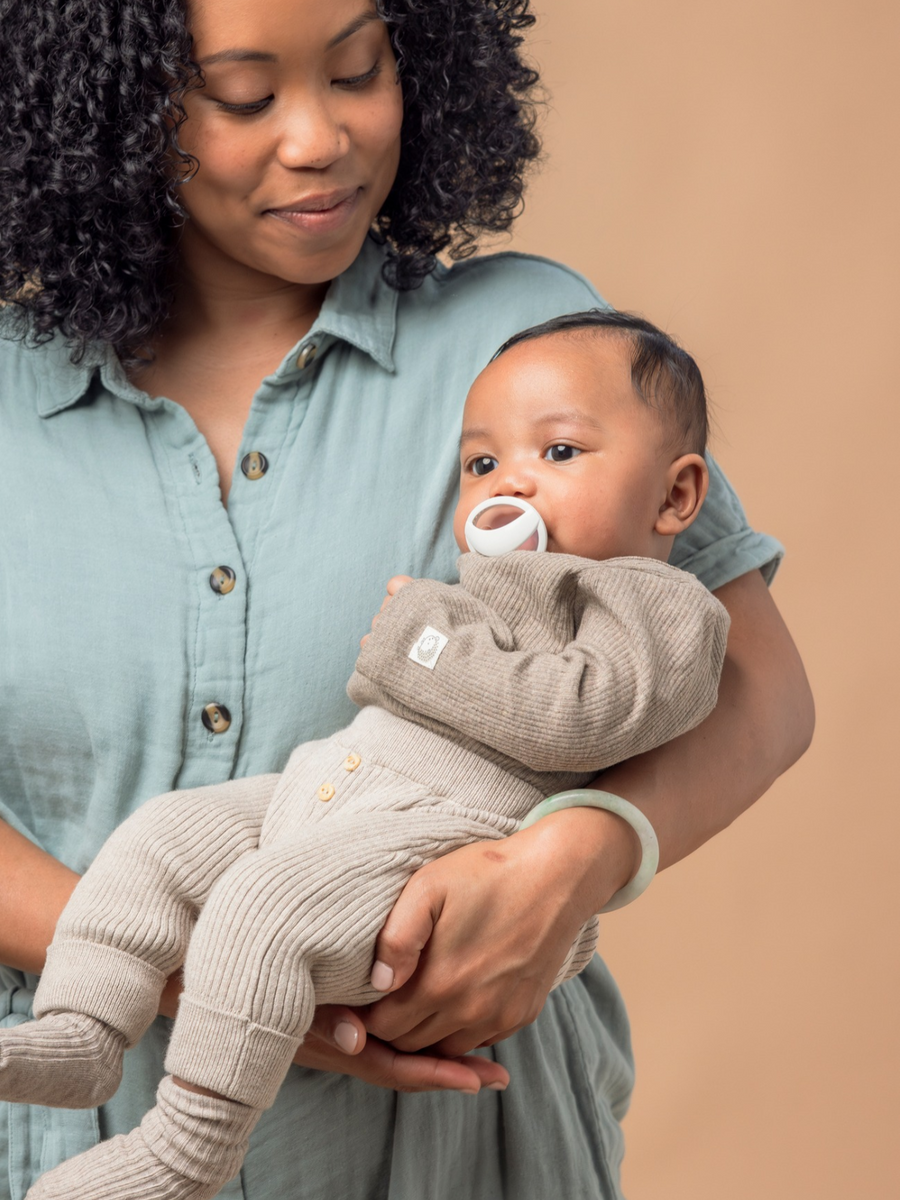 Parent with baby and NUK soother